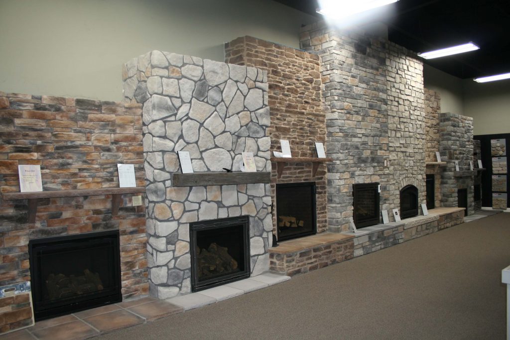 Stone fireplaces in showroom of Top Quality Building Products